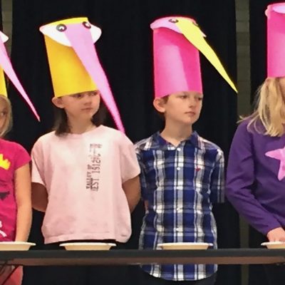 four kids wearing hat bird